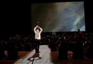 Clarinetist Kari Krikku, conductor Esa-Pekka Salonen, and members of the New York Philharmonic in Kaija Saariaho's "Circle Map" at the Park Avenue Armory